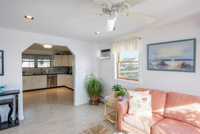 159 Araca Rd, Babylon, NY 11702 - living room with light wood-style flooring, arched walkways, ceiling fan, and recessed lighting