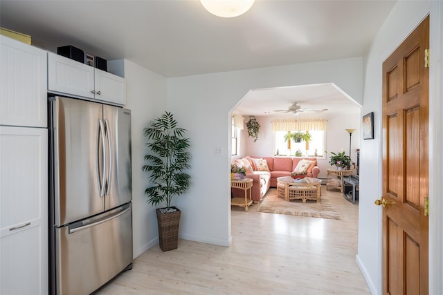 159 Araca Rd, Babylon, NY 11702 - kitchen with freestanding refrigerator, light wood finished floors, baseboards, and white cabinetry