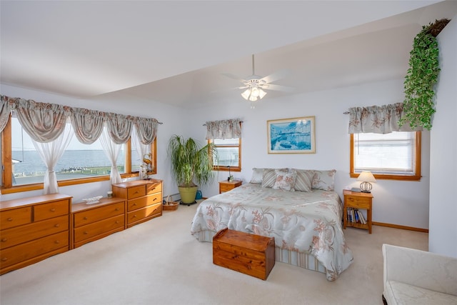 159 Araca Rd, Babylon, NY 11702 - bedroom featuring light carpet, multiple windows, and a ceiling fan