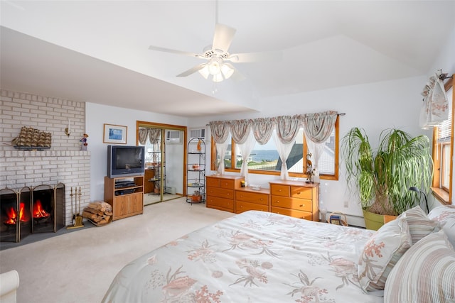 159 Araca Rd, Babylon, NY 11702 - bedroom with light colored carpet, a closet, a brick fireplace, ceiling fan, and a wall mounted air conditioner