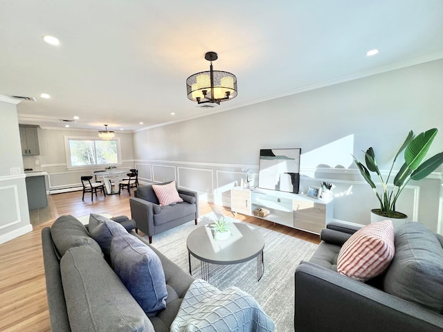 88 Stewart Ave, Hicksville, NY 11801 - living area featuring an inviting chandelier, a decorative wall, a wainscoted wall, a baseboard heating unit, and ornamental molding