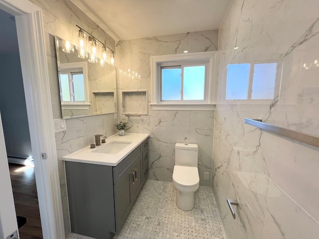 88 Stewart Ave, Hicksville, NY 11801 - bathroom featuring toilet, a baseboard heating unit, a healthy amount of sunlight, and tile walls