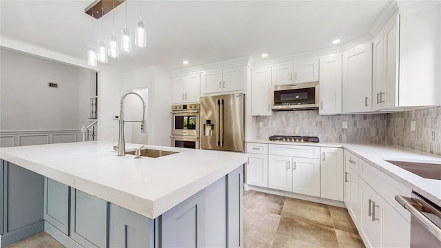 kitchen featuring stainless steel appliances, a sink, backsplash, light countertops, and recessed lighting