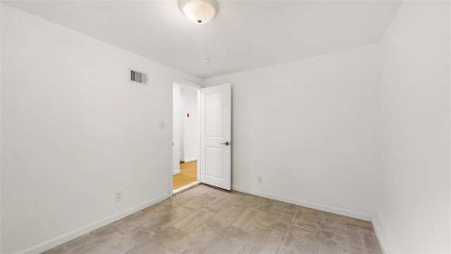 unfurnished room with baseboards