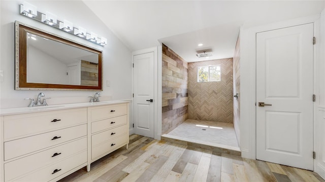 bathroom with a walk in shower, wood finished floors, double vanity, and recessed lighting