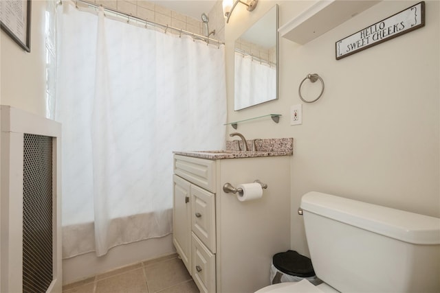 bathroom with toilet, tile patterned flooring, a heating unit, and vanity