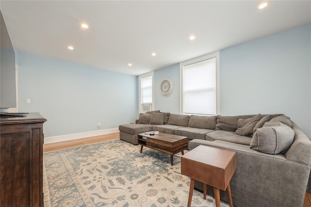 living area featuring light wood finished floors, baseboards, and recessed lighting