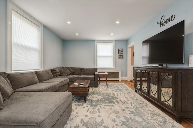 living area with recessed lighting, baseboards, and wood finished floors