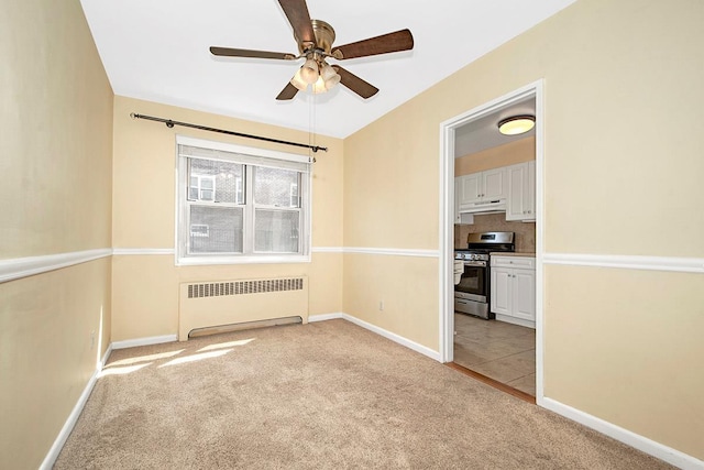 121 N Broadway # 31A, White Plains, NY 10603 - empty room featuring radiator, light colored carpet, ceiling fan, and baseboards