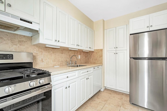 121 N Broadway # 31A, White Plains, NY 10603 - kitchen with appliances with stainless steel finishes, a sink, under cabinet range hood, light countertops, and white cabinets