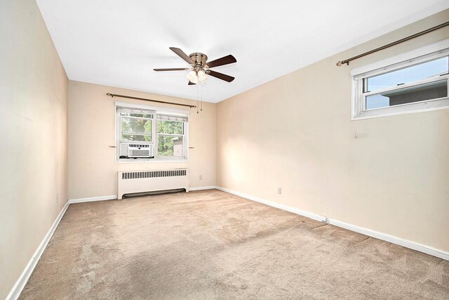 121 N Broadway # 31A, White Plains, NY 10603 - empty room with radiator heating unit, a ceiling fan, carpet, and healthy amount of natural light
