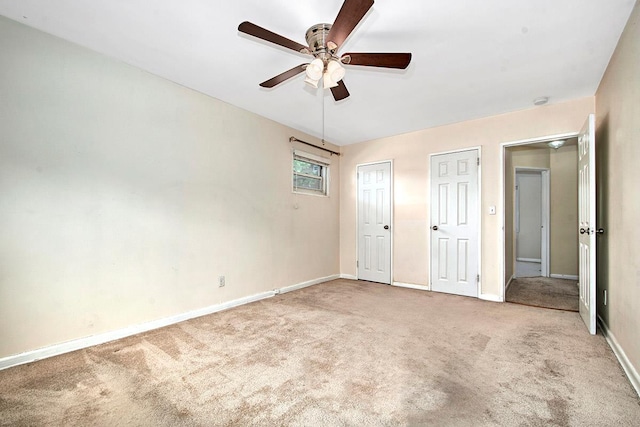 121 N Broadway # 31A, White Plains, NY 10603 - unfurnished bedroom with light colored carpet, two closets, baseboards, and a ceiling fan