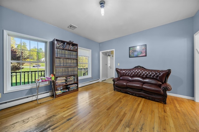 10-12 Damian Ct, Chester, NY 10918 - living area featuring hardwood / wood-style floors, a baseboard heating unit, and baseboards