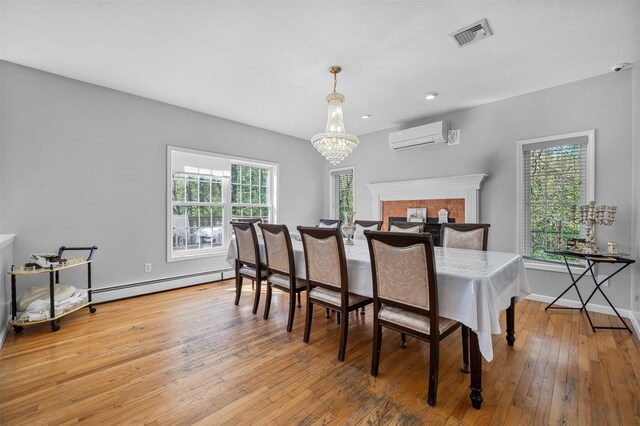 10-12 Damian Ct, Chester, NY 10918 - dining space featuring a baseboard heating unit, a wall mounted air conditioner, hardwood / wood-style flooring, a chandelier, and baseboards