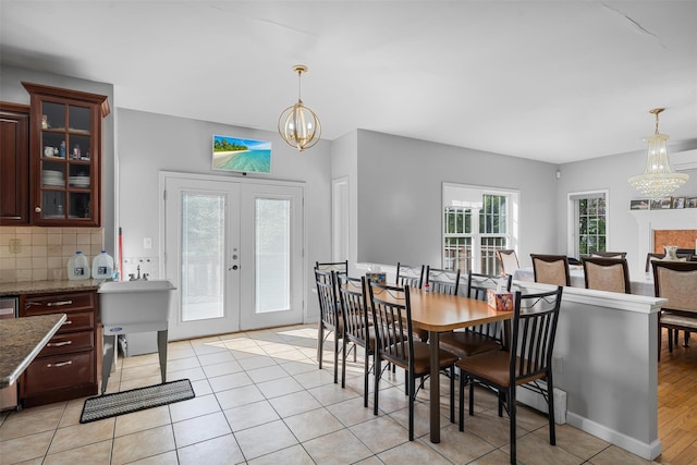 10-12 Damian Ct, Chester, NY 10918 - dining area featuring a chandelier, french doors, and light tile patterned floors
