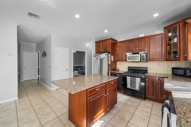 10-12 Damian Ct, Chester, NY 10918 - kitchen featuring black appliances, light tile patterned flooring, backsplash, a sink, and a center island