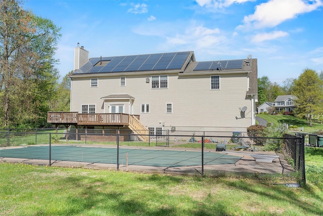 10-12 Damian Ct, Chester, NY 10918 - back of house featuring a wooden deck, solar panels, a chimney, and stairs