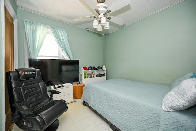 bedroom featuring crown molding and a ceiling fan