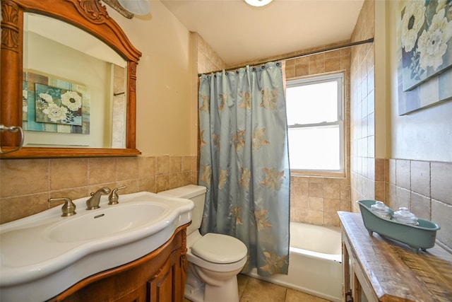bathroom featuring vanity, toilet, tile walls, shower / bathtub combination with curtain, and tile patterned floors