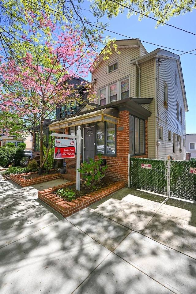 view of front of property with fence and a gate