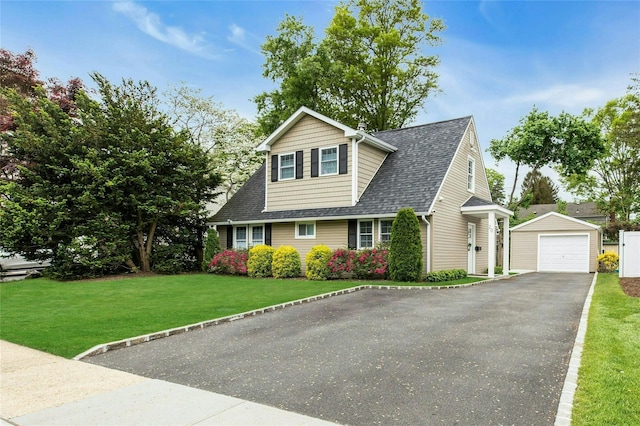 20 Robert Rd, Glen Cove, NY 11542 - view of front of property featuring an outbuilding, a garage, roof with shingles, a front lawn, and asphalt driveway