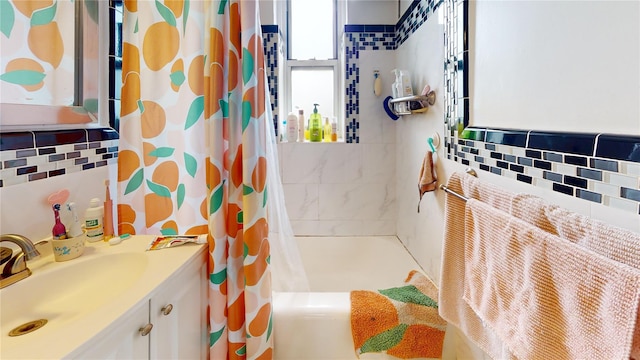 bathroom featuring vanity, shower / bath combo with shower curtain, and decorative backsplash