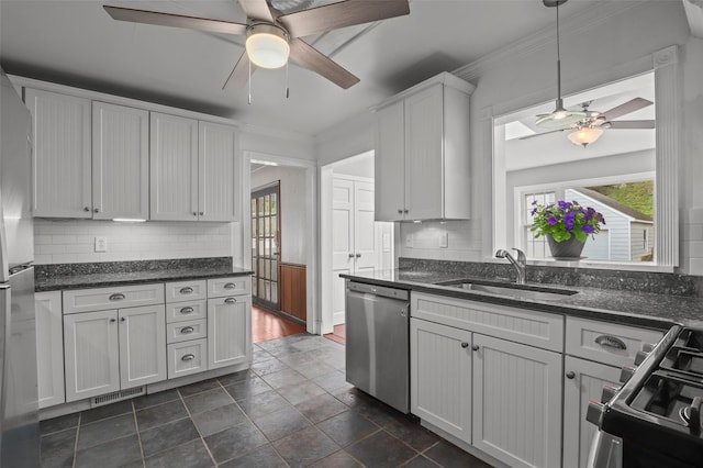 kitchen featuring a ceiling fan, a healthy amount of sunlight, stainless steel appliances, and a sink
