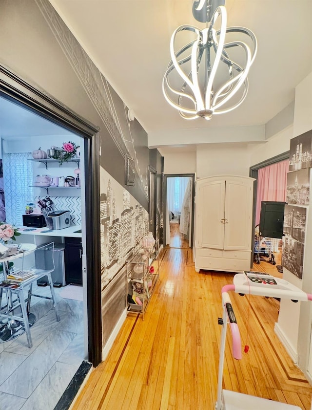 interior space featuring an inviting chandelier and light wood finished floors