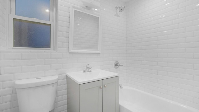 bathroom with vanity, toilet, tile walls, shower / bathing tub combination, and backsplash