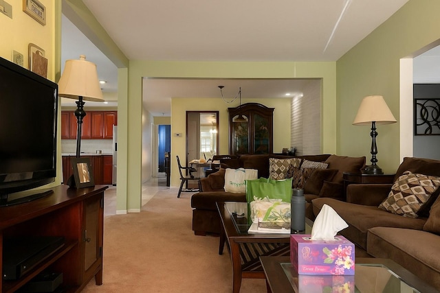 living area featuring light carpet