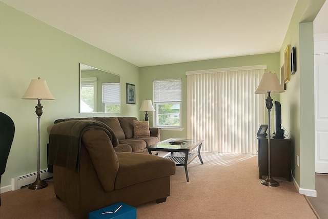 living area featuring light carpet, baseboards, and a baseboard radiator