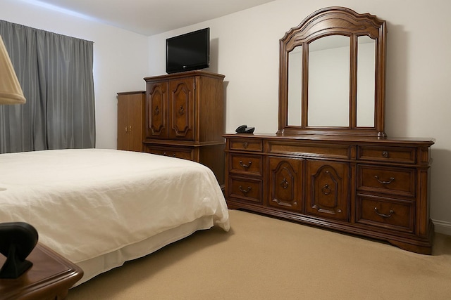 bedroom featuring light carpet