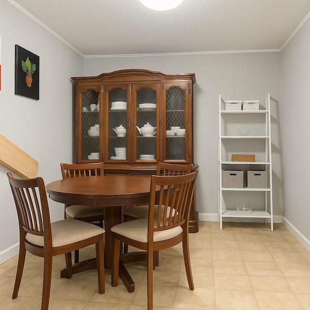 dining area featuring baseboards and ornamental molding