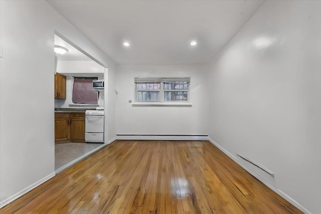3135 Gunther Ave, Bronx, NY 10469 - interior space with baseboards, light wood finished floors, and baseboard heating