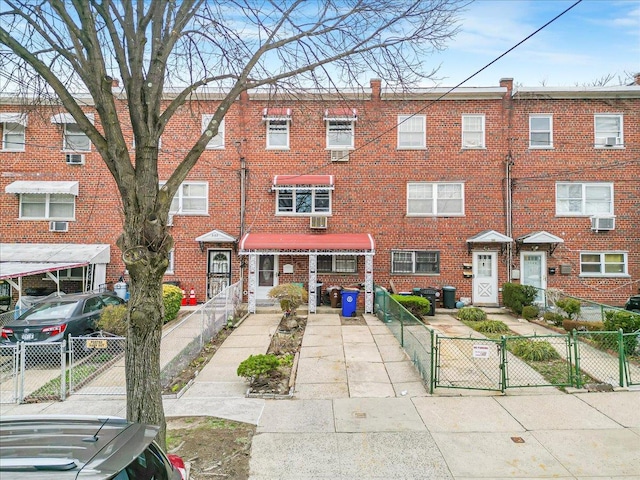 3135 Gunther Ave, Bronx, NY 10469 - view of property with brick siding, fence private yard, and a gate