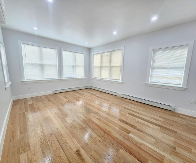 empty room with light wood-style floors, recessed lighting, baseboards, and a healthy amount of sunlight