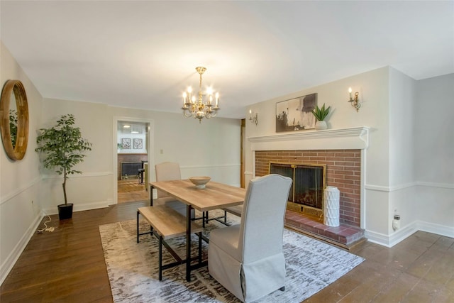711 Homestead Ave, Maybrook, NY 12543 - dining space featuring a chandelier, a brick fireplace, baseboards, and wood finished floors