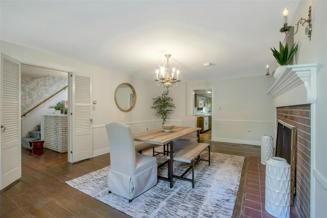 711 Homestead Ave, Maybrook, NY 12543 - dining area featuring baseboards, an inviting chandelier, stairs, hardwood / wood-style flooring, and a fireplace