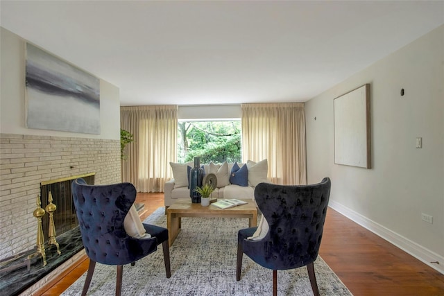 711 Homestead Ave, Maybrook, NY 12543 - living area with a brick fireplace, baseboards, and wood finished floors