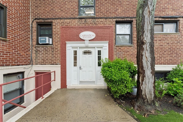 91 Tulip Ave Unit B1, Cartion, Floral Park, NY 11001 - doorway to property with brick siding and cooling unit