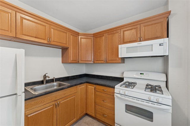 91 Tulip Ave Unit B1, Cartion, Floral Park, NY 11001 - kitchen with white appliances, a sink, dark countertops, and brown cabinets