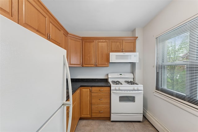 91 Tulip Ave Unit B1, Cartion, Floral Park, NY 11001 - kitchen with white appliances, dark countertops, and brown cabinets