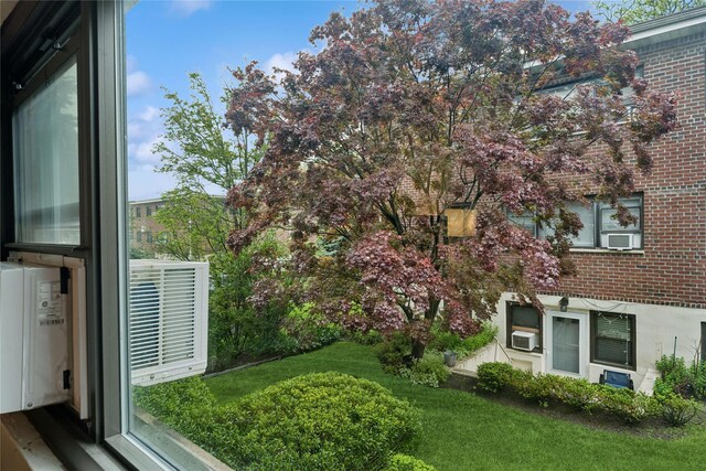 91 Tulip Ave Unit B1, Cartion, Floral Park, NY 11001 - view of grassy yard featuring cooling unit