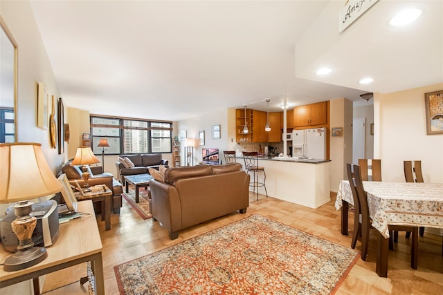 living area with recessed lighting and baseboards