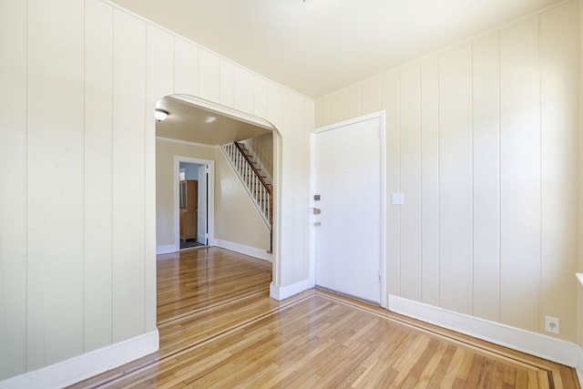 3399 Ely Ave, Bronx, NY 10469 - empty room featuring stairs, arched walkways, baseboards, and light wood-type flooring