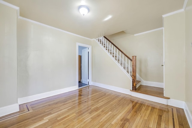 3399 Ely Ave, Bronx, NY 10469 - unfurnished living room featuring stairs, baseboards, ornamental molding, and hardwood / wood-style floors