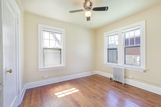 3399 Ely Ave, Bronx, NY 10469 - empty room with a ceiling fan, baseboards, radiator heating unit, and hardwood / wood-style floors