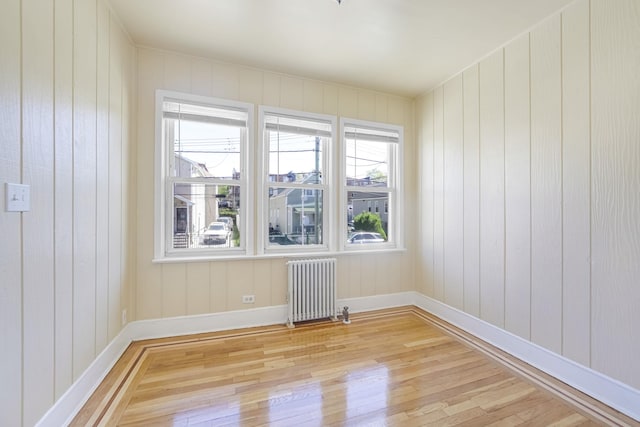 3399 Ely Ave, Bronx, NY 10469 - unfurnished room with baseboards, light wood-style flooring, and radiator heating unit