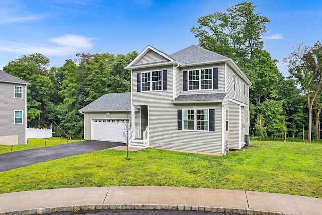 214 Phillips St, Middletown, NY 10940 - view of front facade with a garage, roof with shingles, driveway, and a front lawn