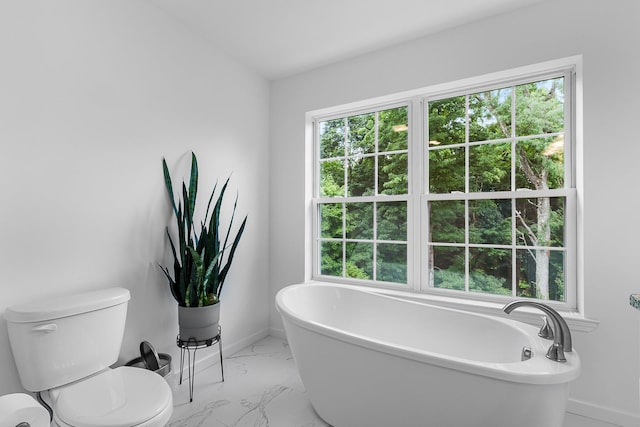 214 Phillips St, Middletown, NY 10940 - full bathroom featuring baseboards, marble finish floor, a freestanding bath, and toilet
